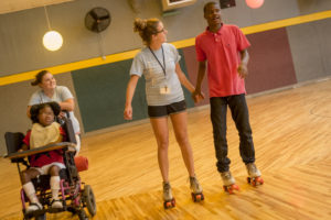 intern rollerskating with boy