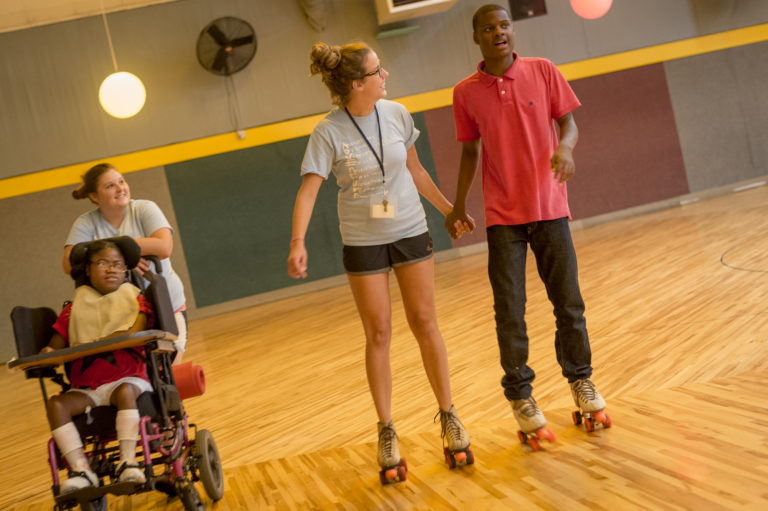 intern rollerskating with boy