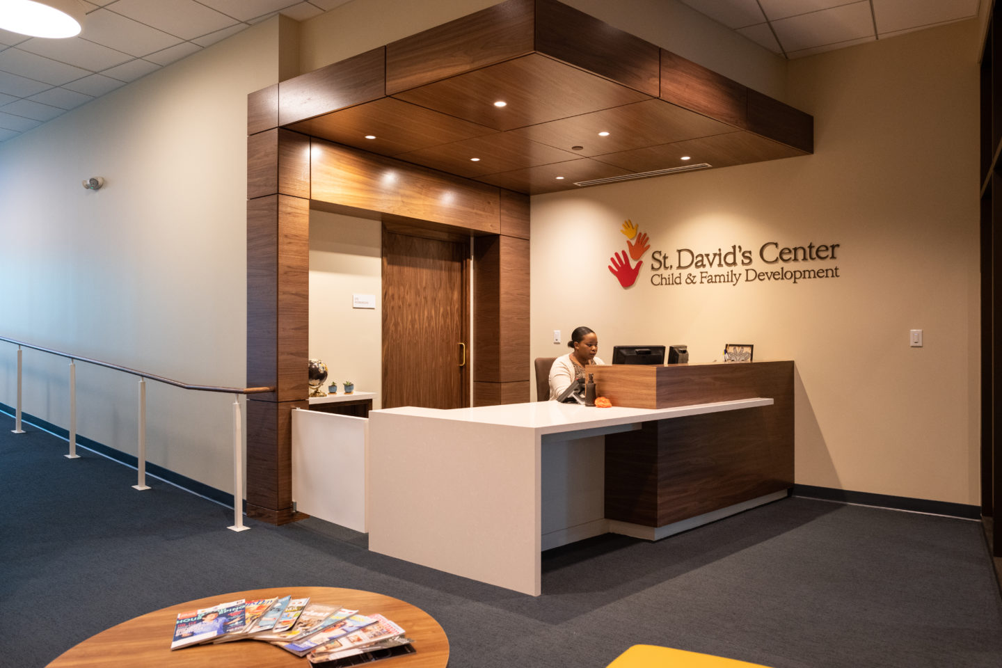 Administrative Assistant working at the front desk of the clinic.